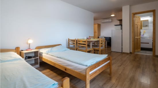 a room with beds and tables