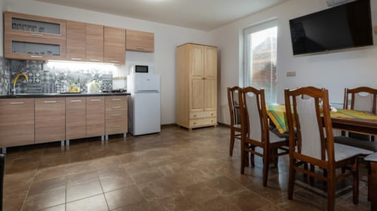 a kitchen with a table and chairs