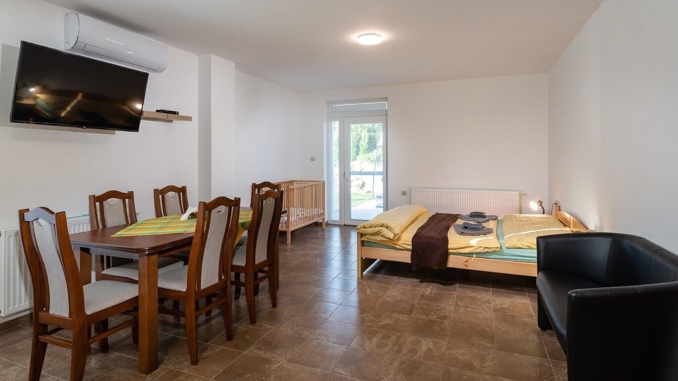 a room with a bed and chairs