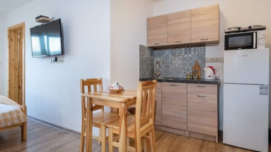 a kitchen with a table and chairs