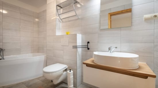 a bathroom with a tub sink and toilet