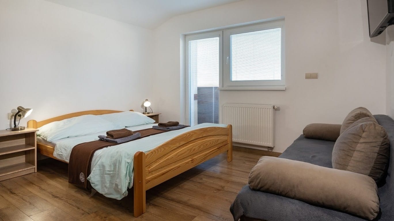 a bedroom with a bed and couch