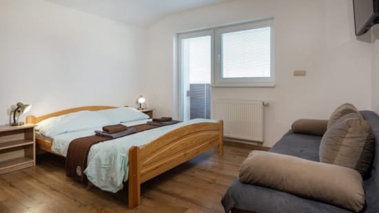 a bedroom with a bed and couch