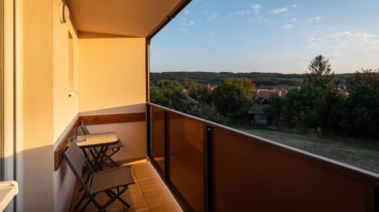 a balcony with a table and chairs