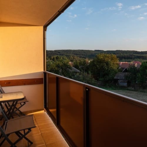 a balcony with a table and chairs