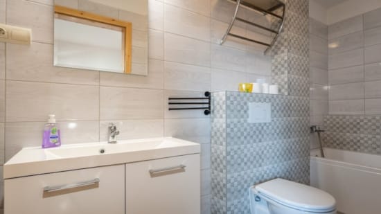 a bathroom with a tub toilet and sink