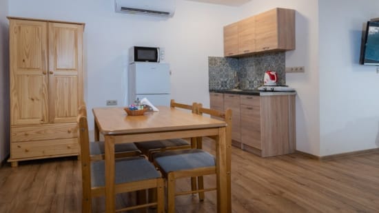 a kitchen with a table and chairs