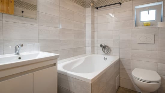 a bathroom with a tub sink and toilet