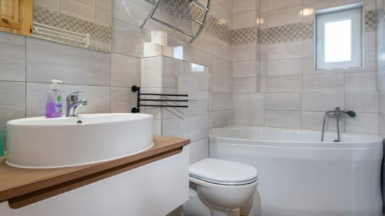 a bathroom with a tub sink and toilet