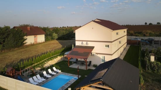 a building with a pool and a grass field