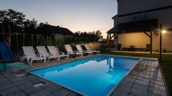 a swimming pool with chairs around it