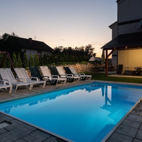 a swimming pool with chairs around it