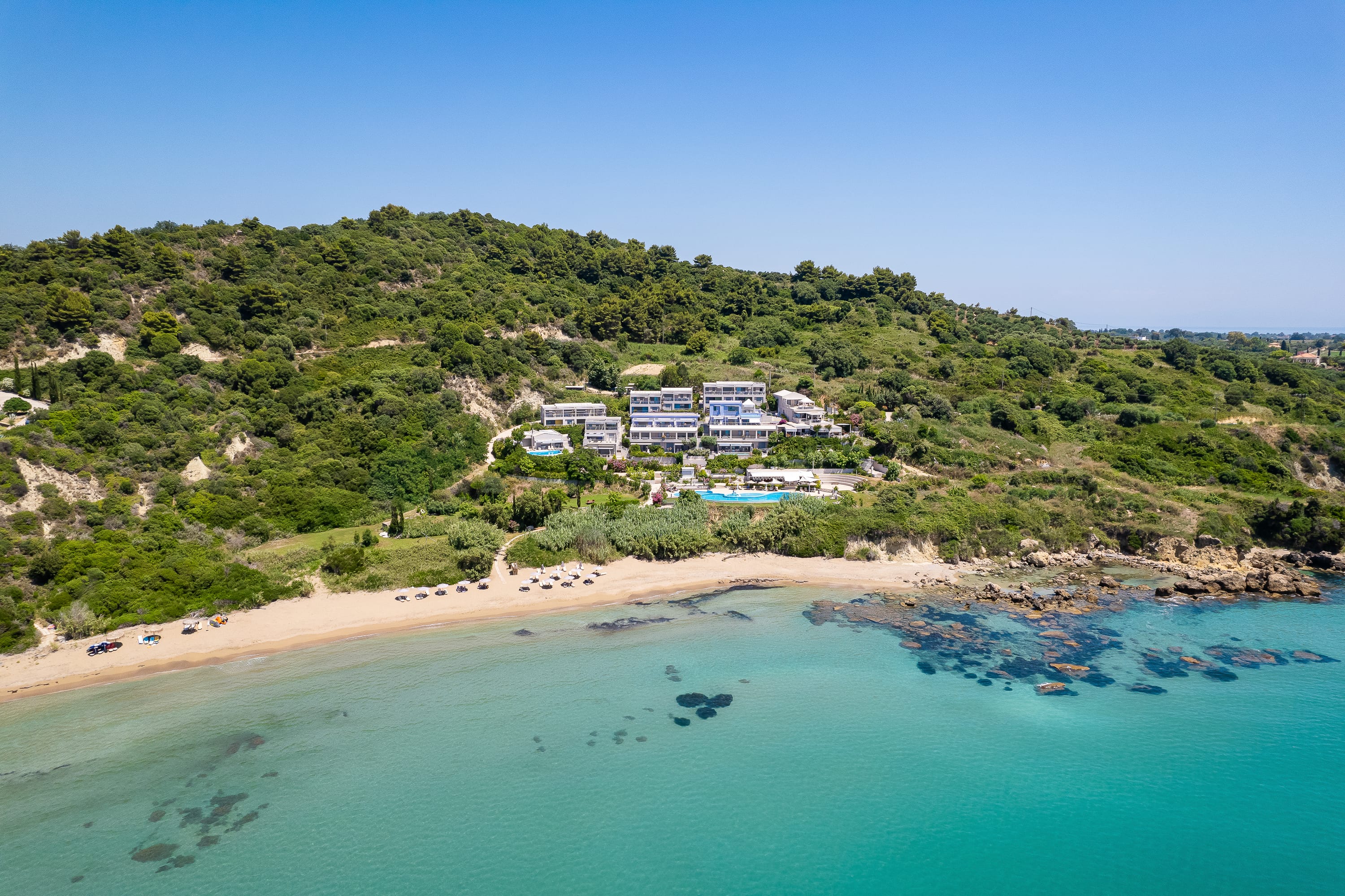 a beach with houses and trees