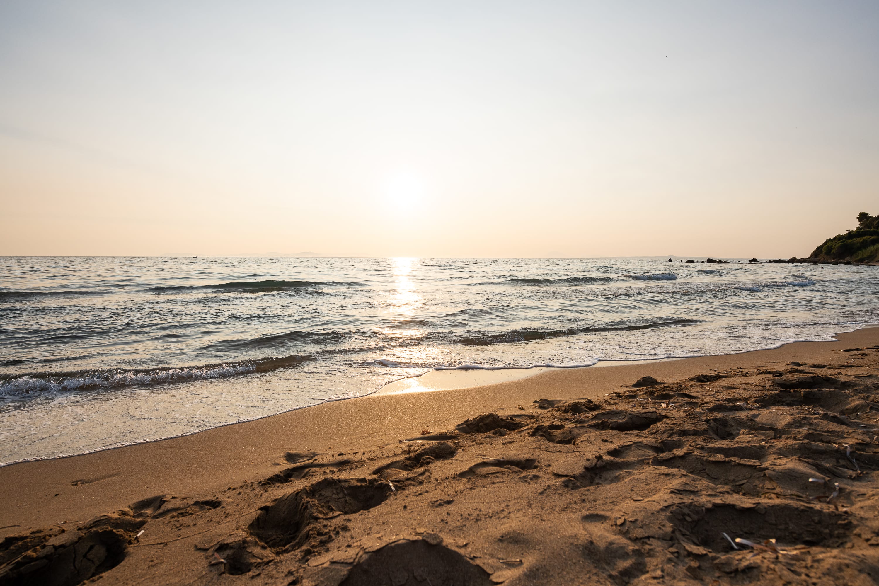 a beach with waves crashing on it