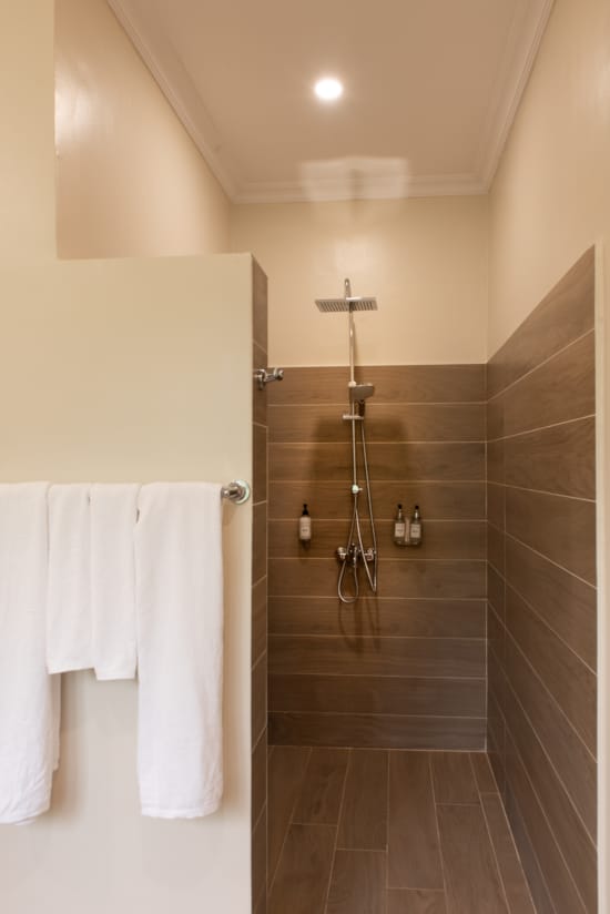 a bathroom with a shower and towels