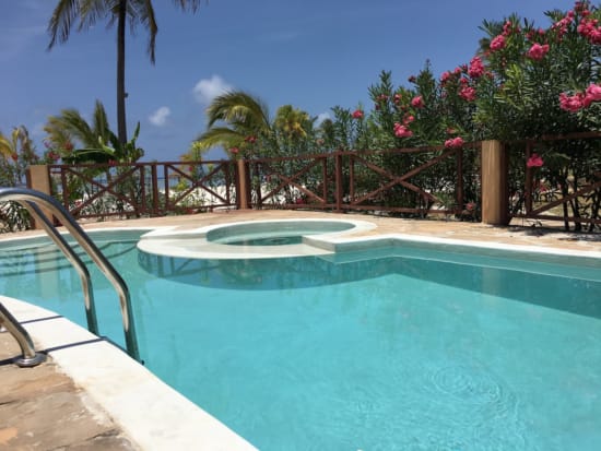 a pool with a deck and trees
