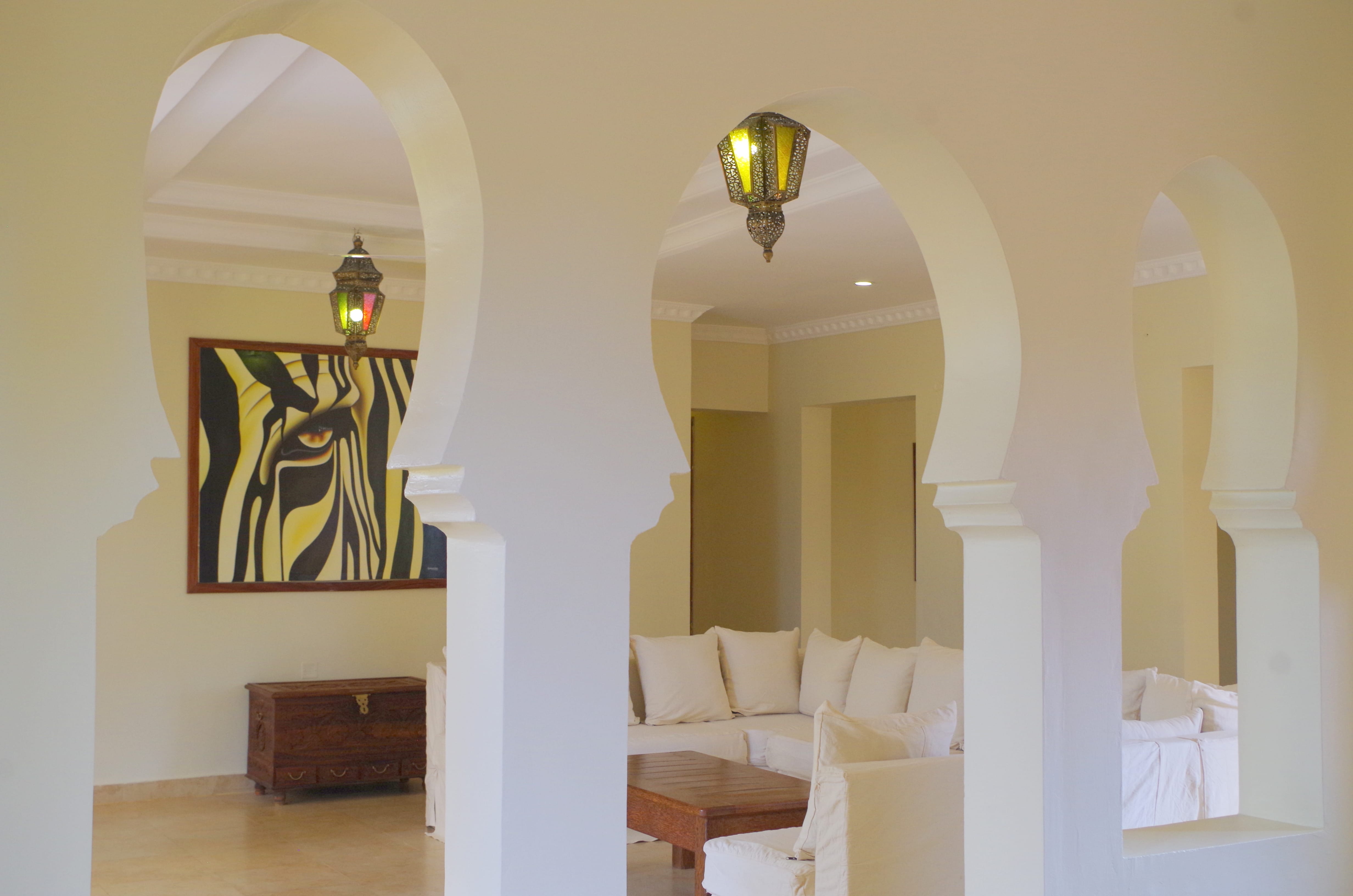 a room with white walls and a chandelier