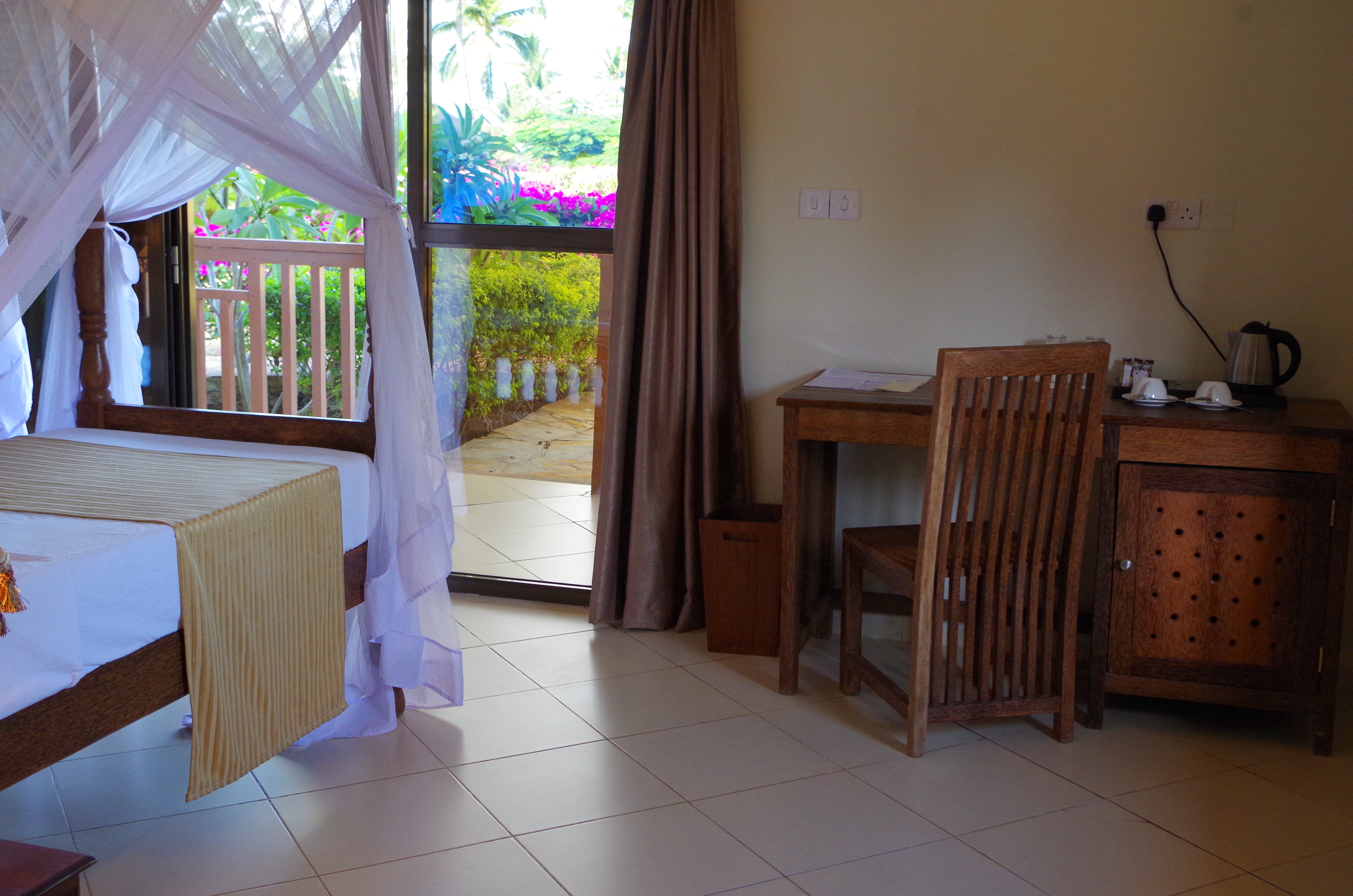 a room with a desk and chairs