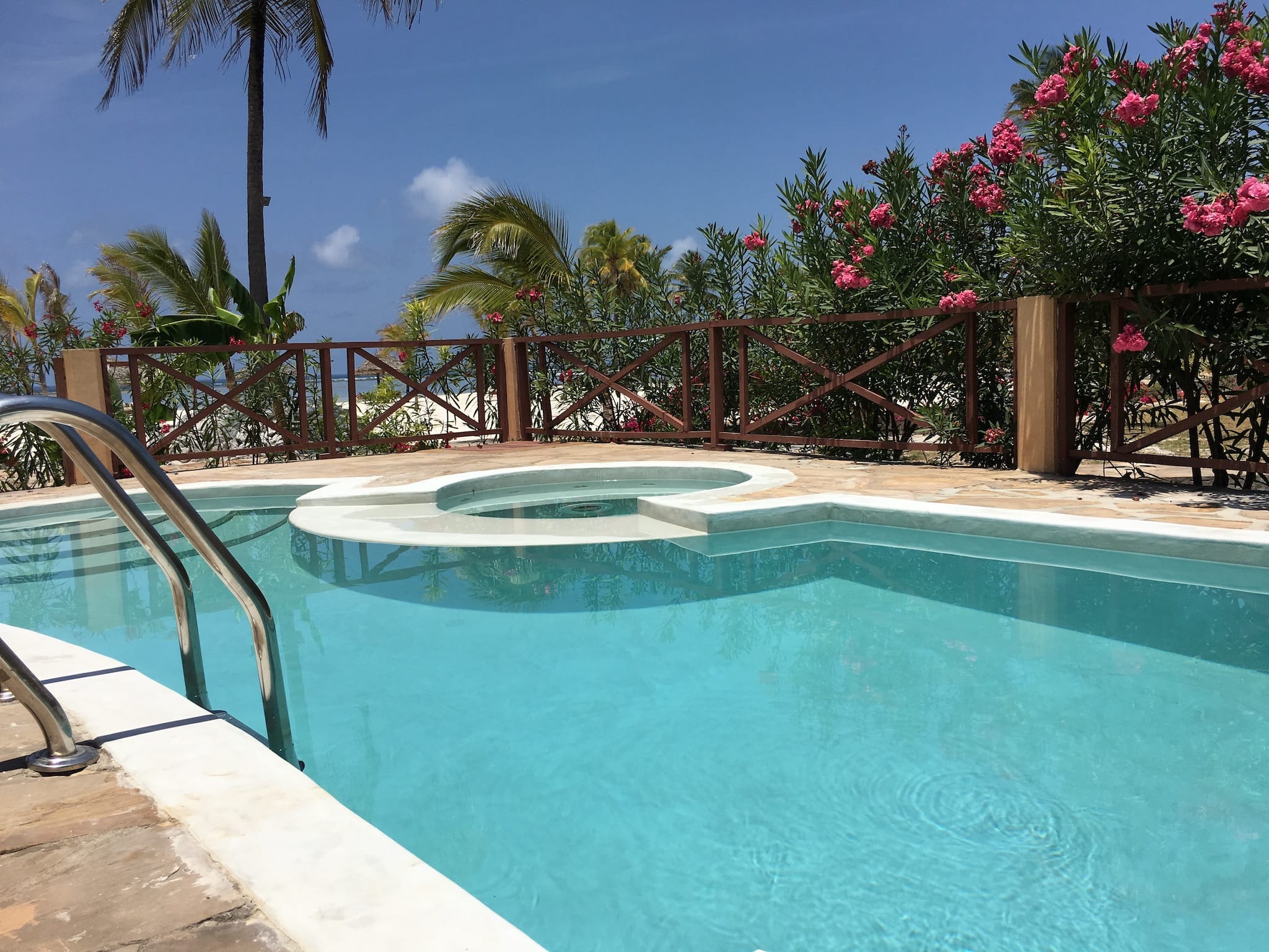a pool with a deck and trees