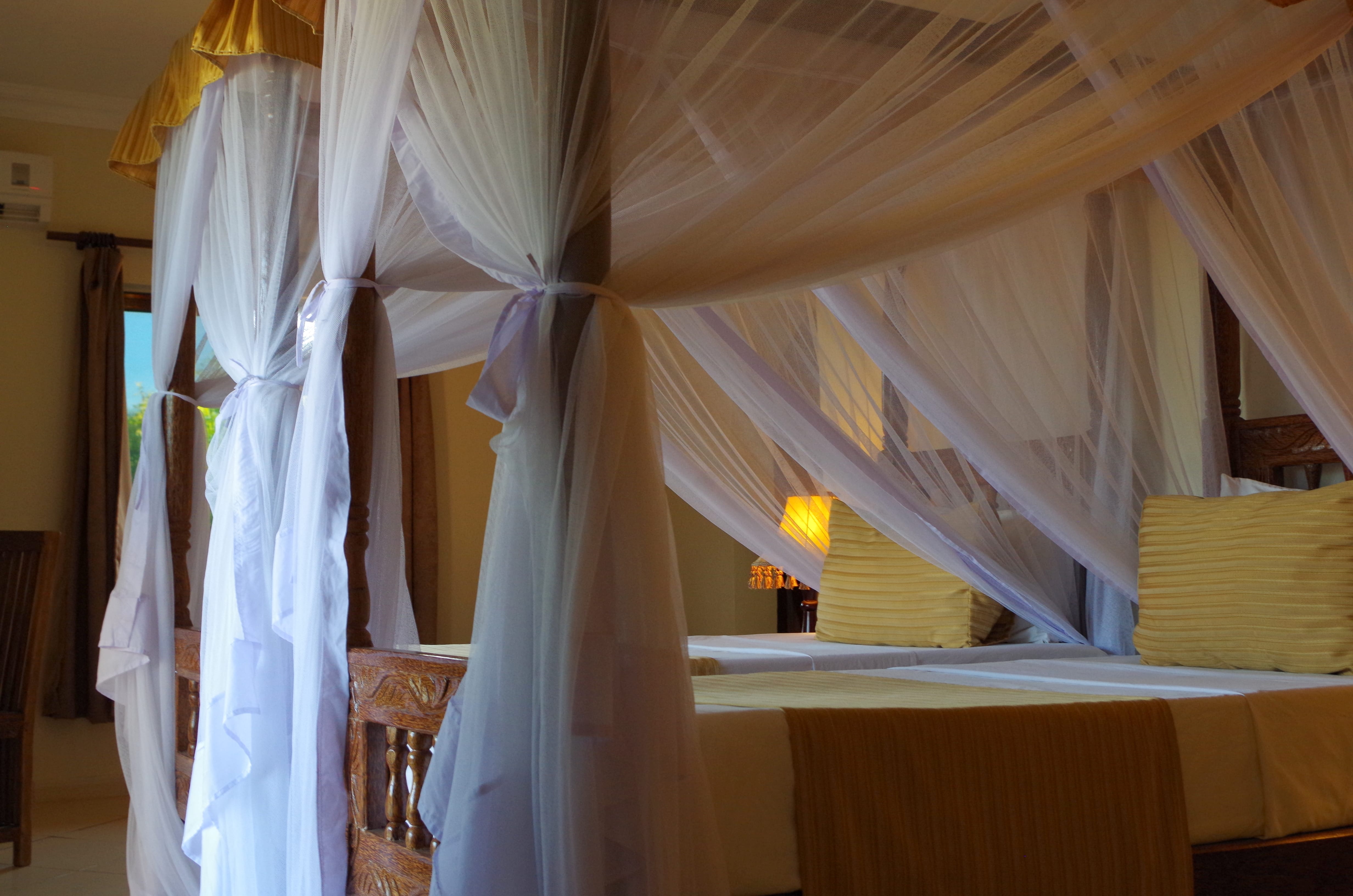 a room with a bed and a table with a lamp