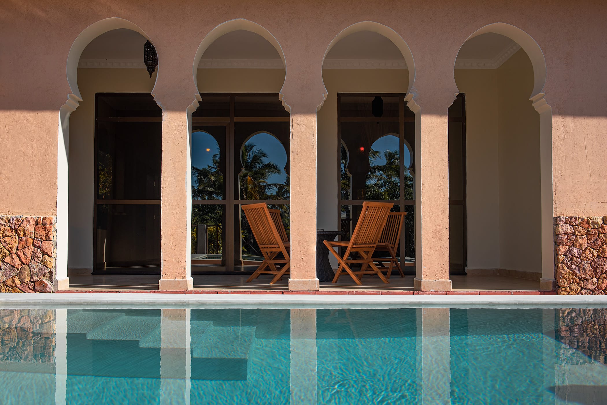 a pool with chairs and a table
