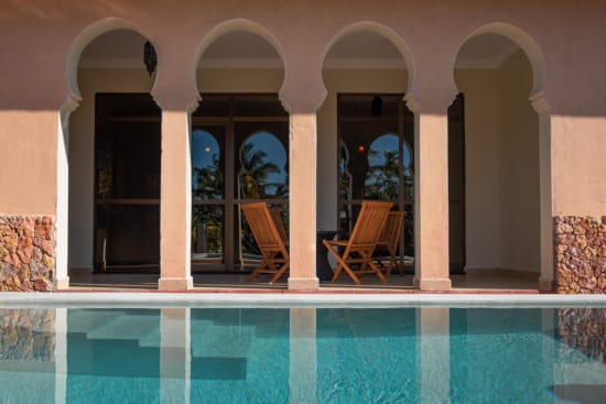 a pool with chairs and a table