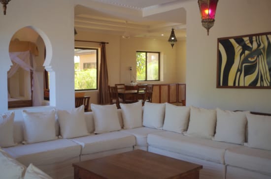 a room with white couches and a table