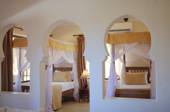 a room with a bed and a mirror