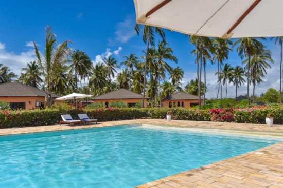 a pool with chairs and umbrellas by it
