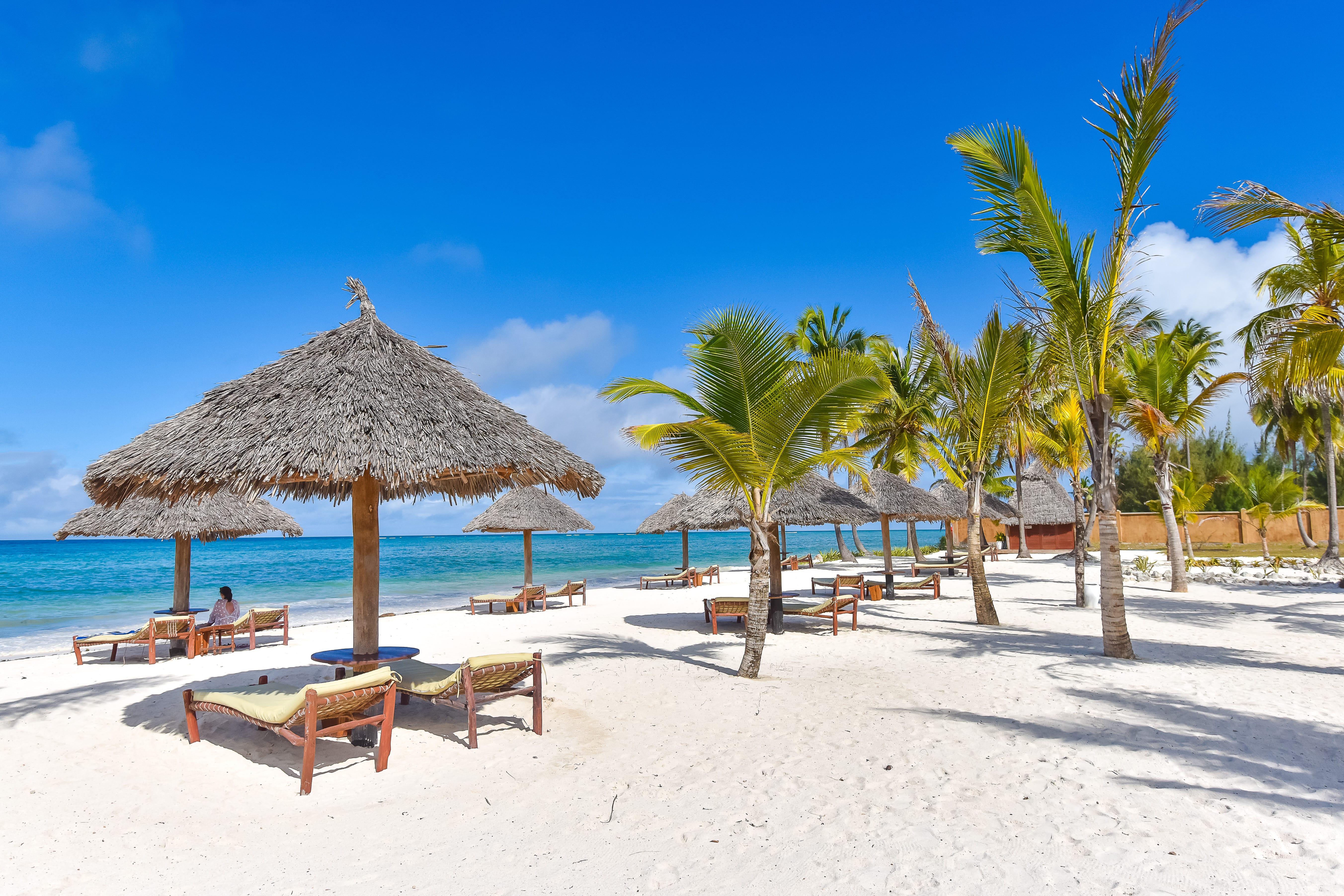 a beach with umbrellas and chairs