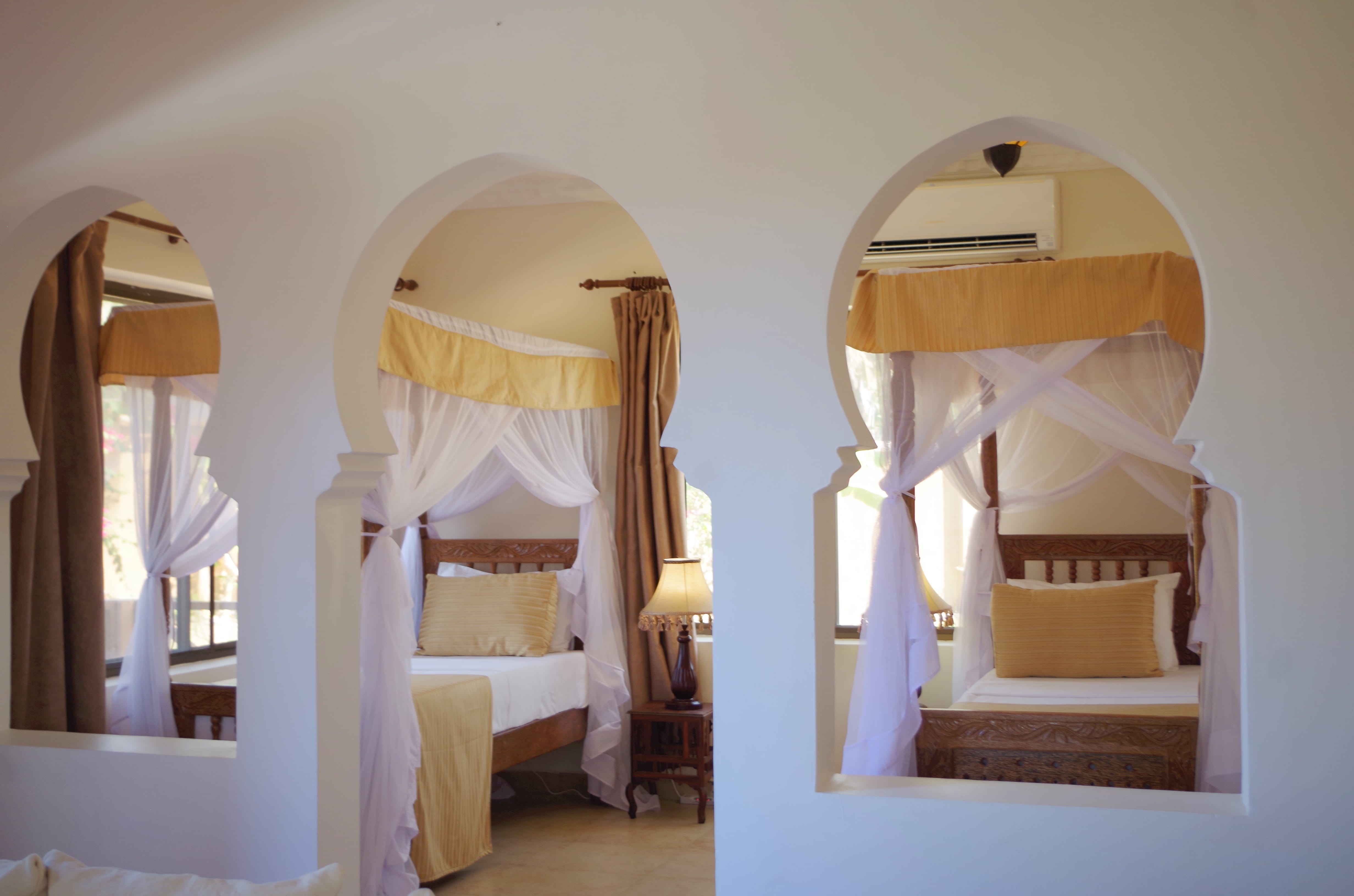 a room with a bed and a mirror