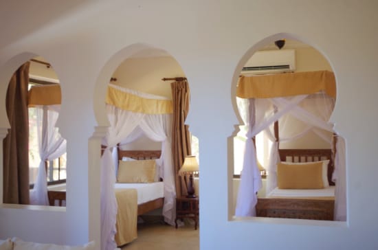 a room with a bed and a mirror