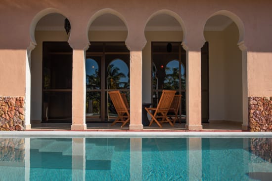a pool with chairs and a table