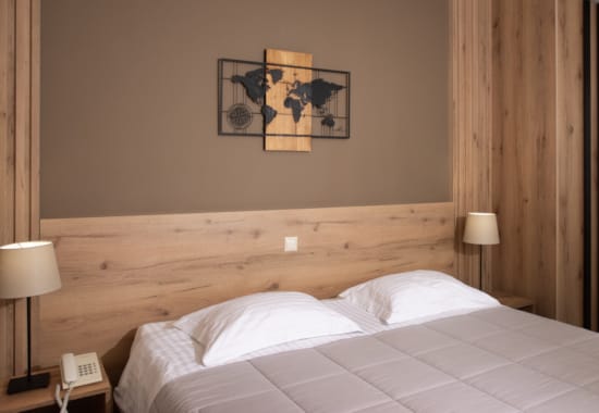 a bed with a painting on the wall