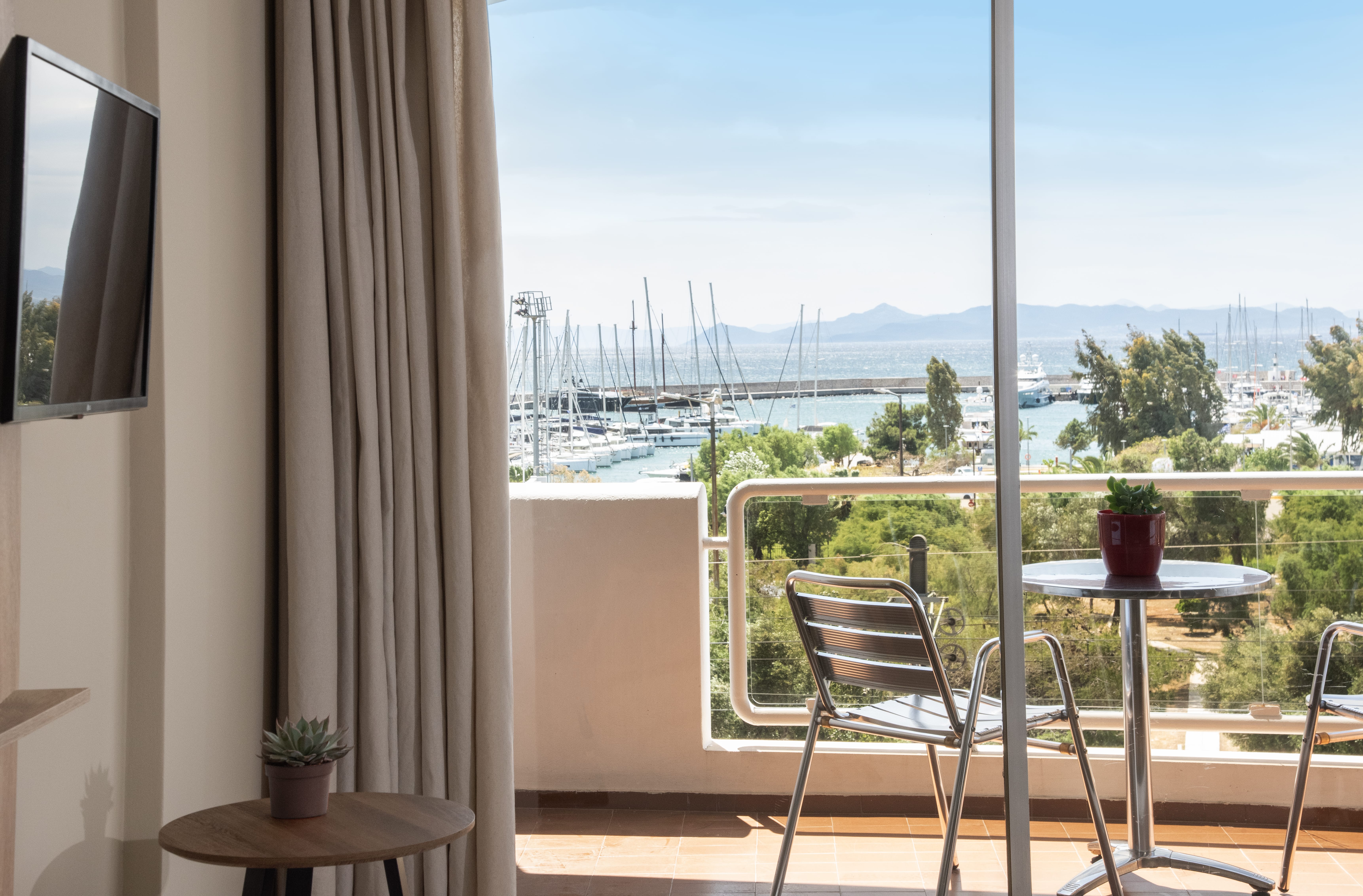 a balcony with a view of the ocean and trees