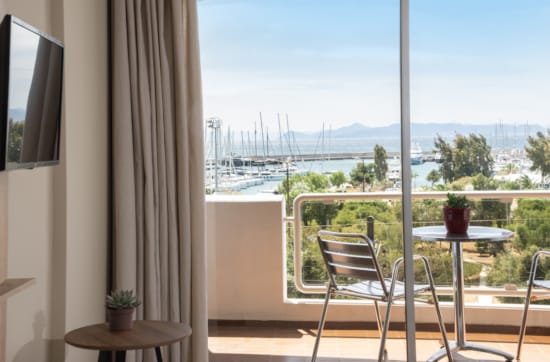 a balcony with a view of the ocean and trees