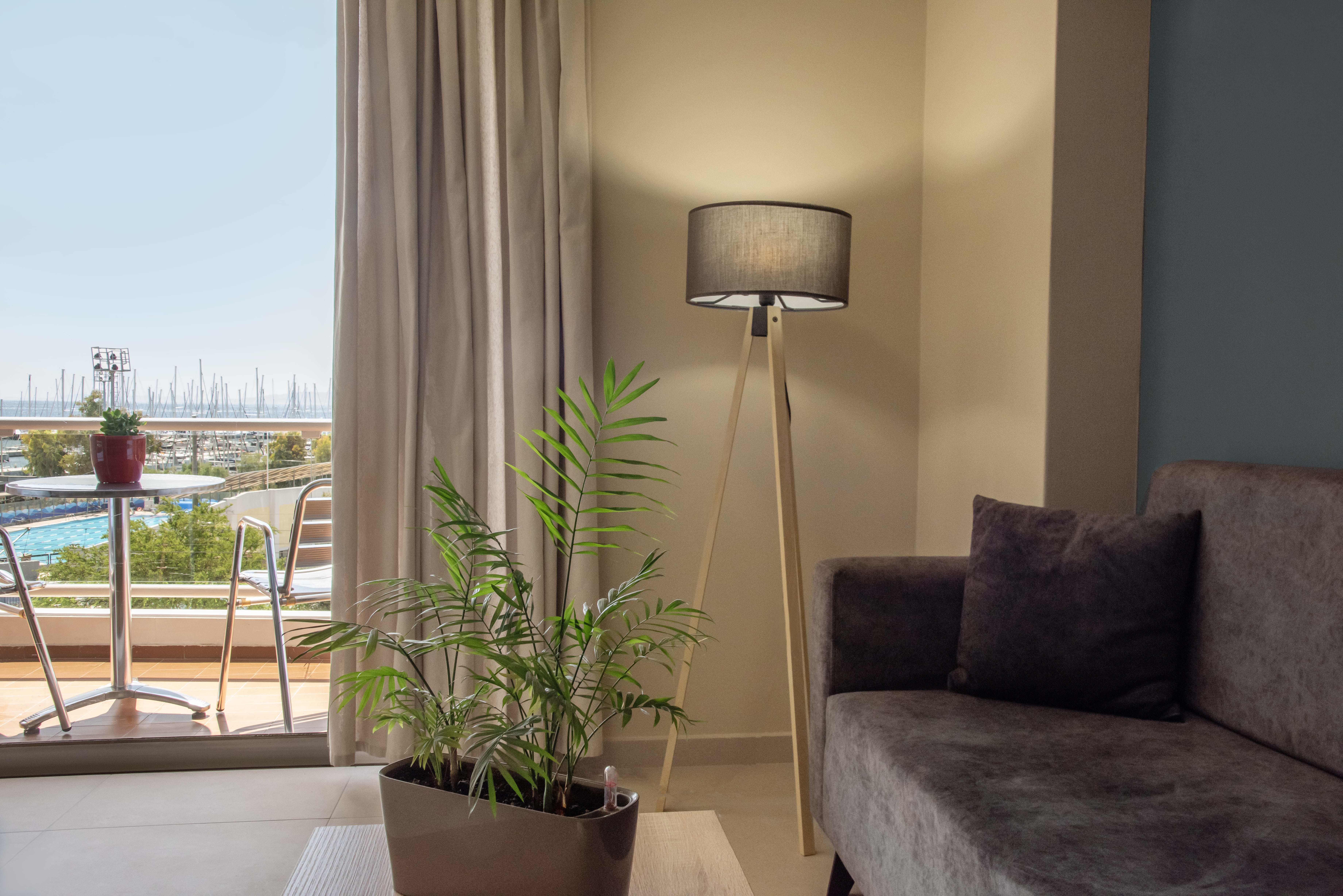a lamp and a plant in a room with a window