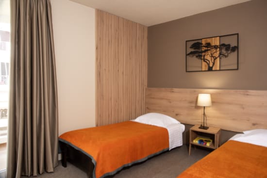 a hotel room with two beds