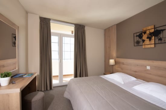 a bedroom with a bed and a desk