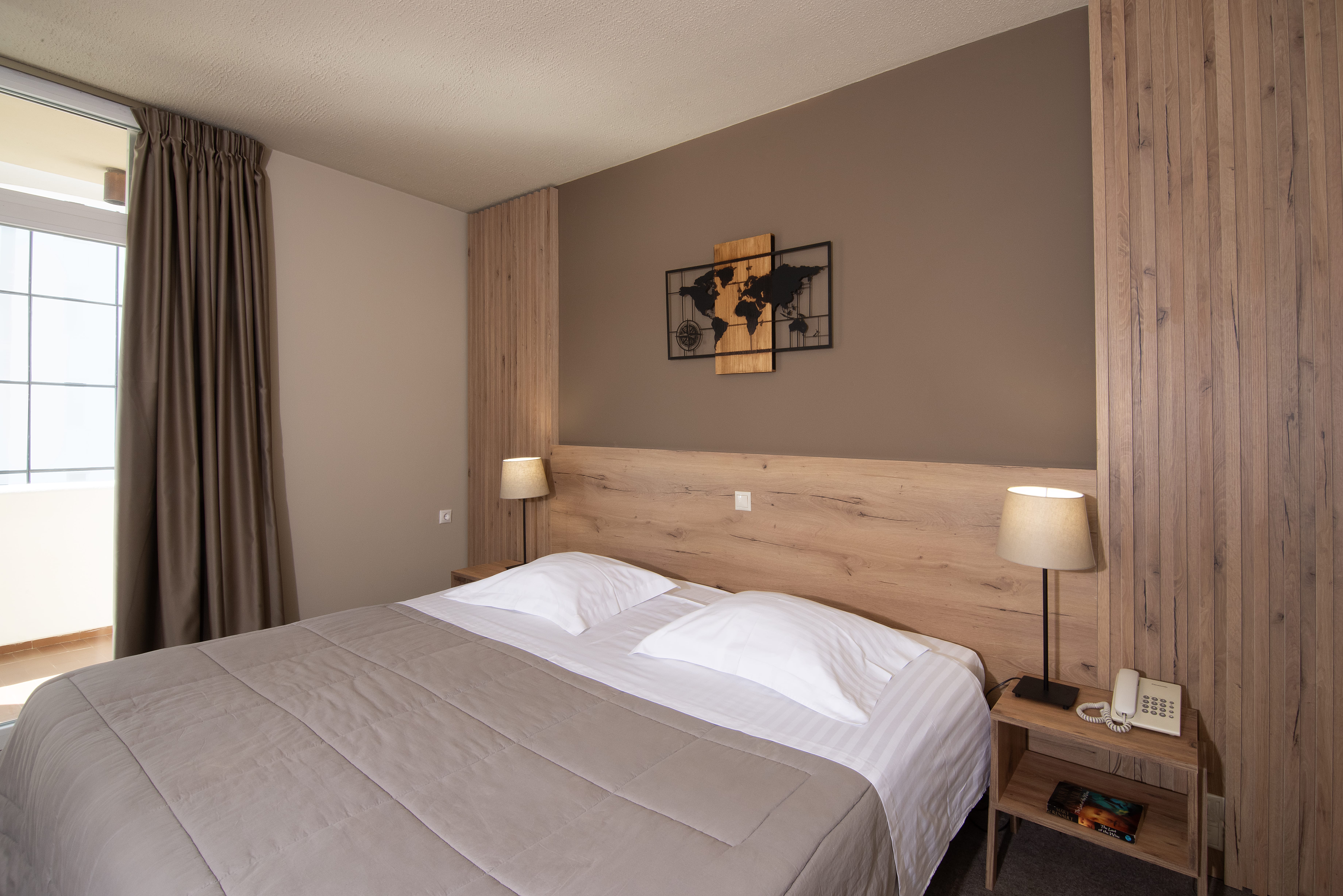 a hotel room with a bed and a lamp