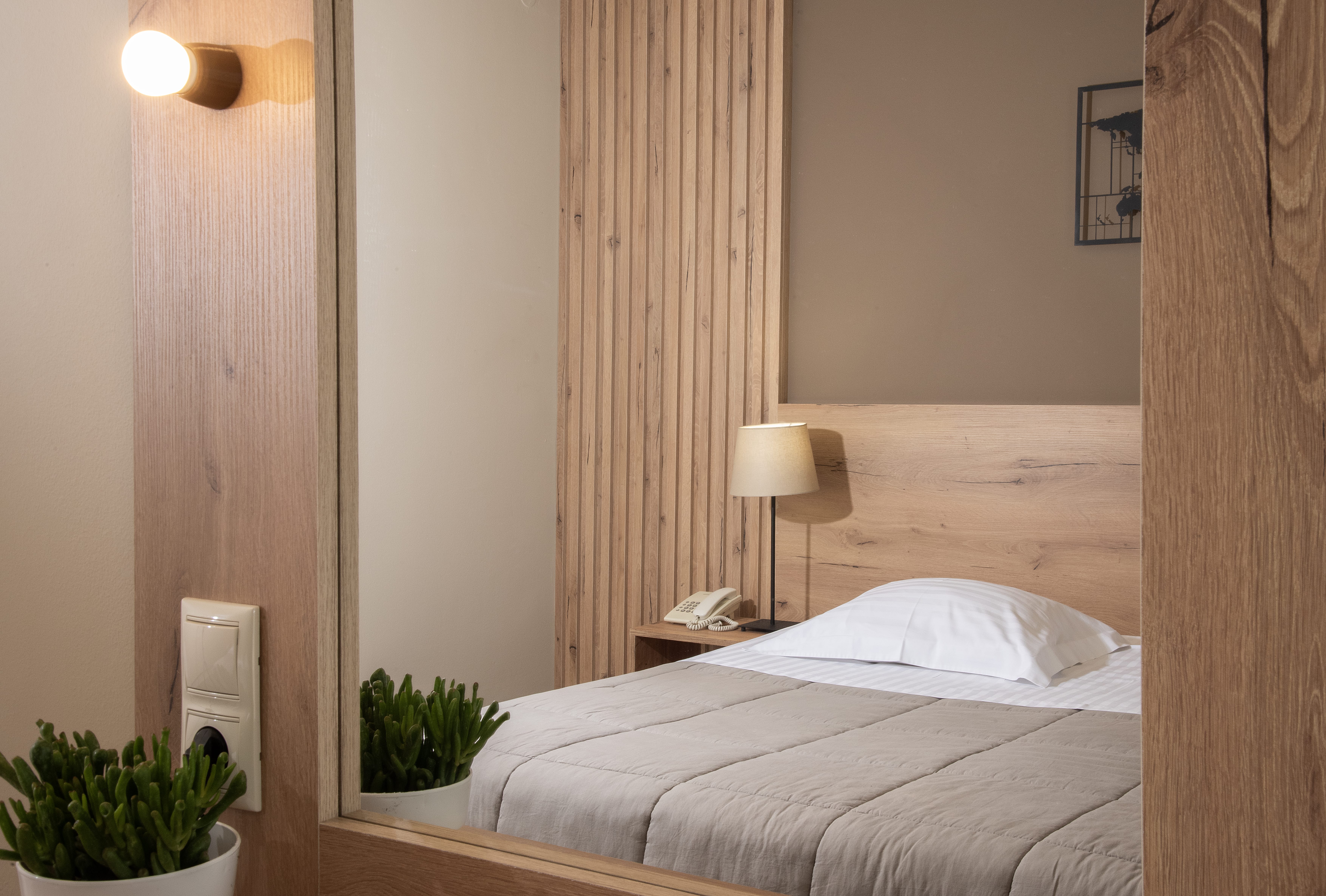 a bed with a lamp on the side