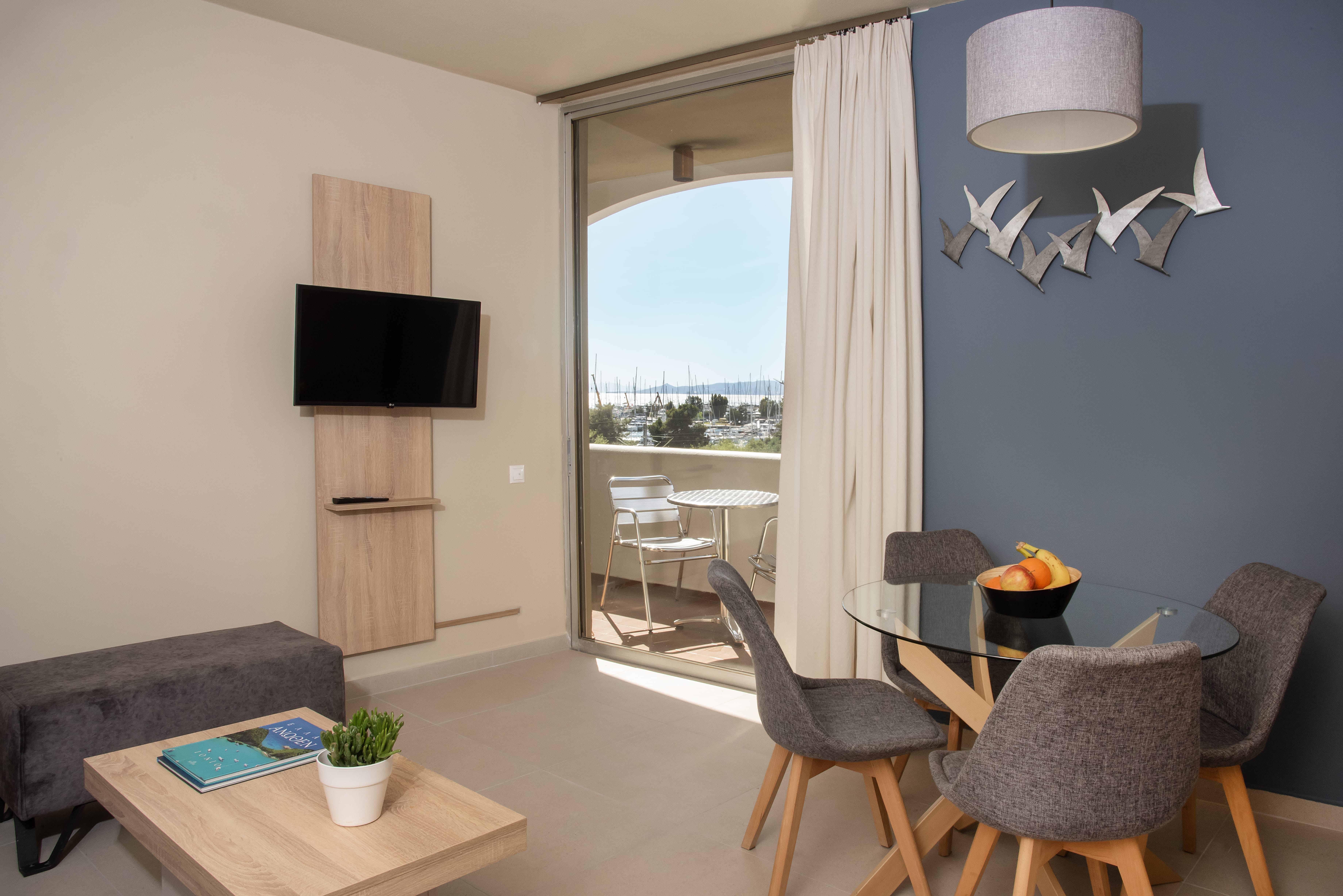 a living room with a tv and chairs