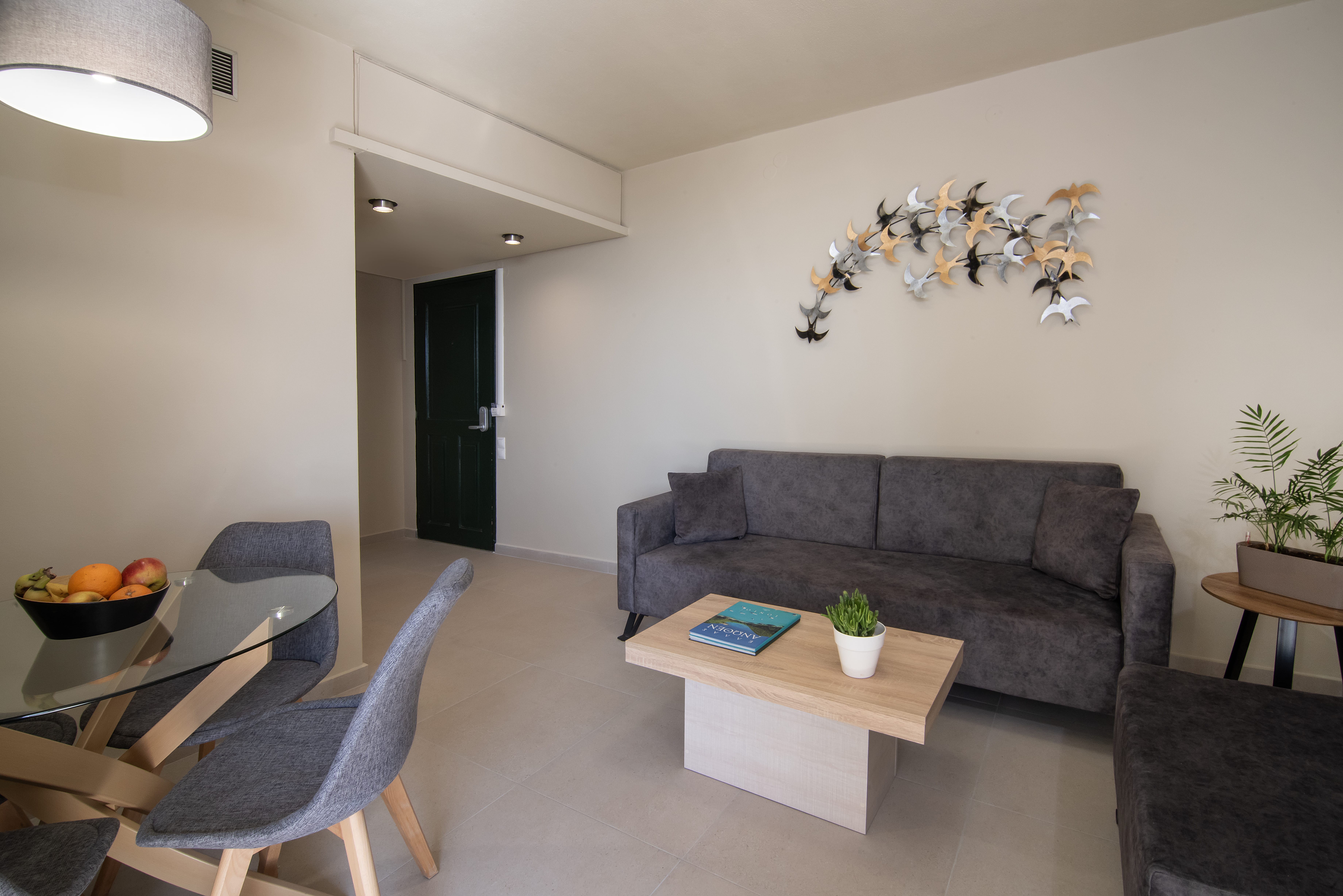 a living room with a couch and chairs