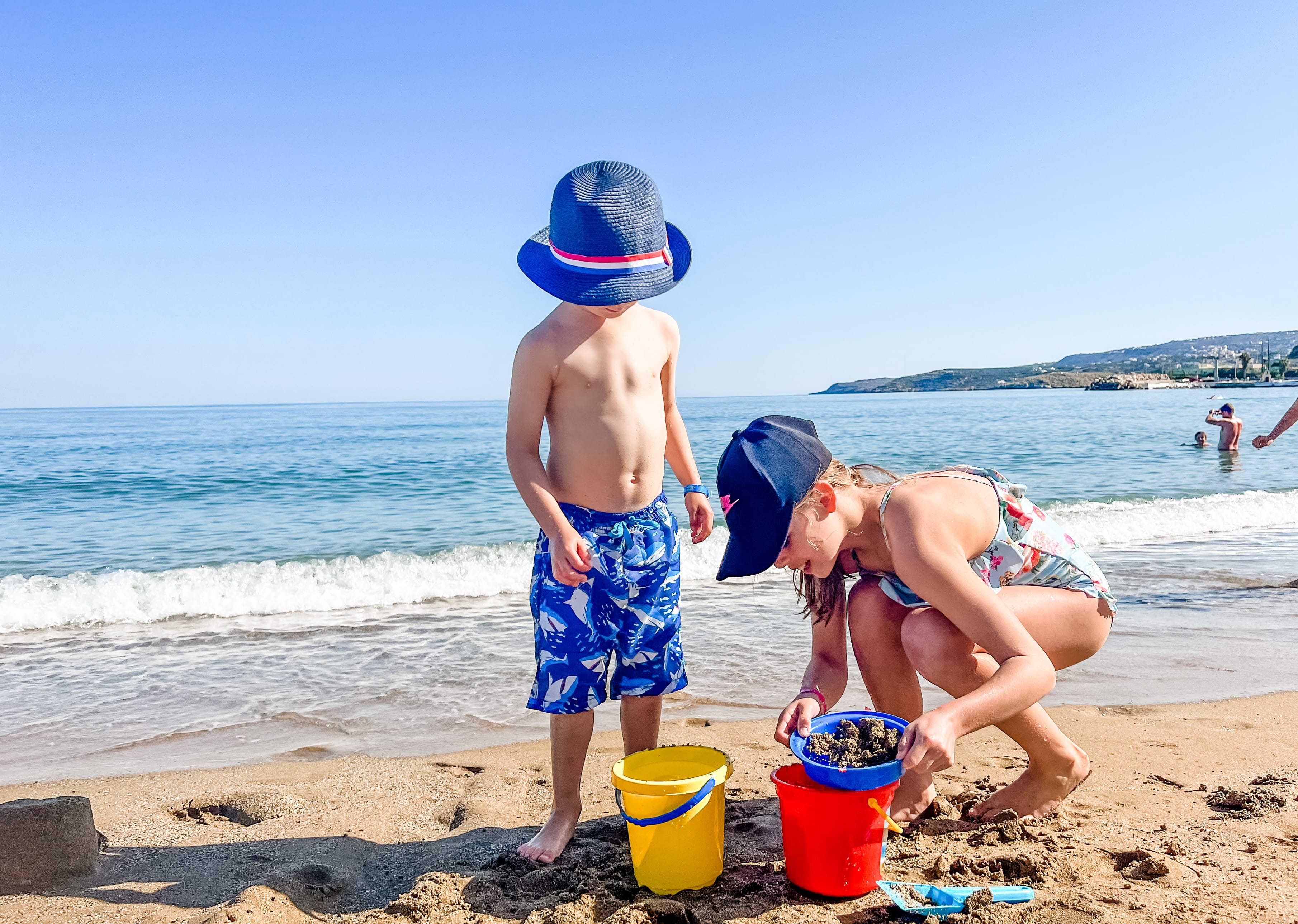 a couple of kids playing on the beach