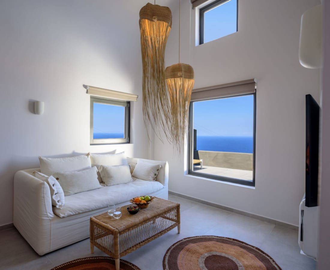 a living room with a white couch and a white table