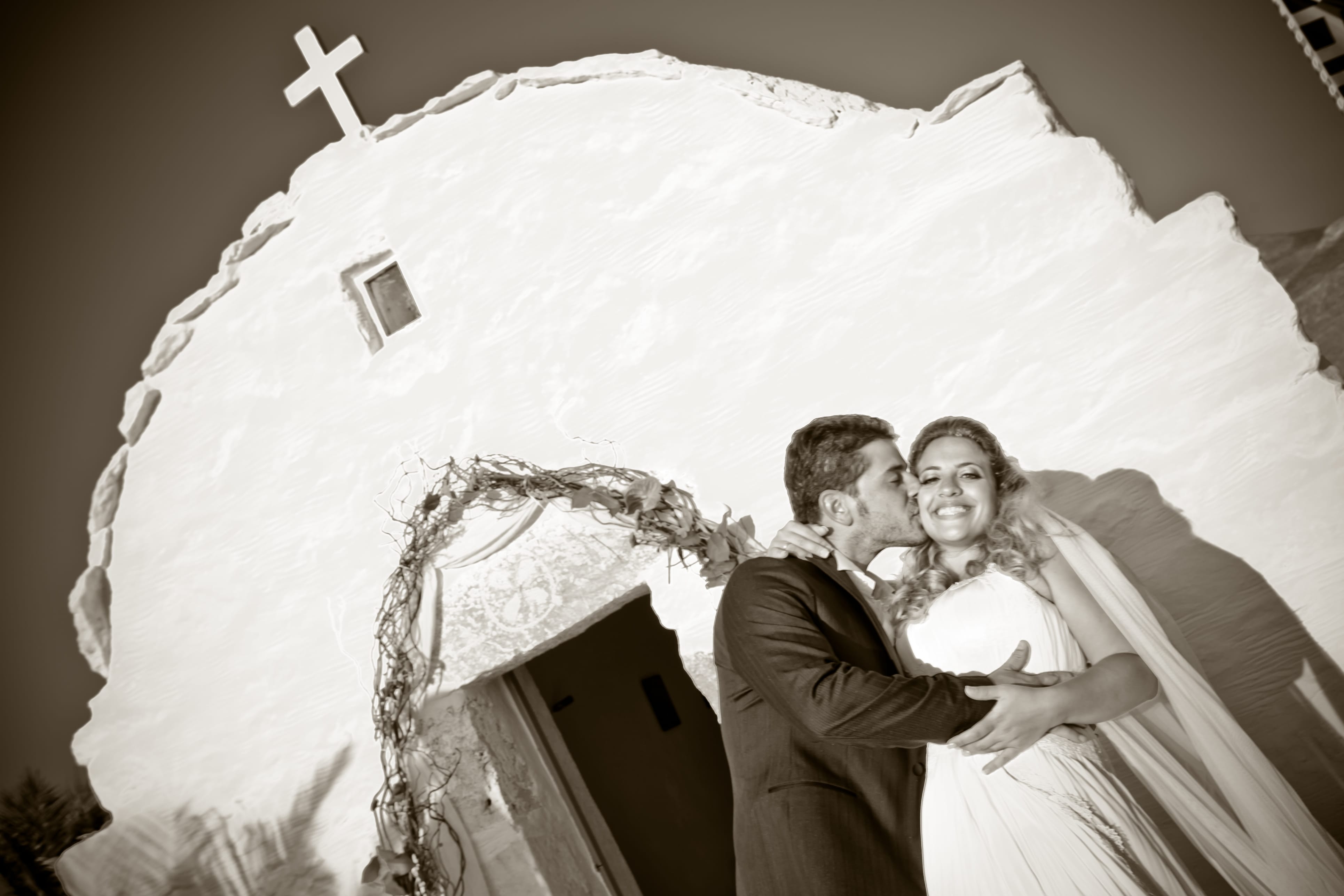 a man and woman posing for a picture in front of a large white sculpture