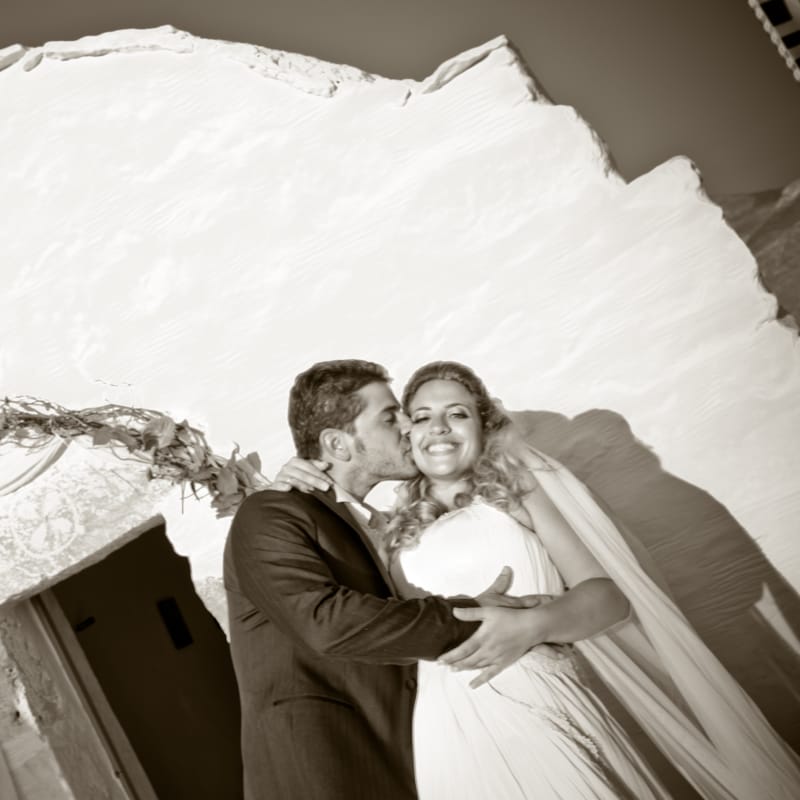 a man and woman posing for a picture in front of a large white sculpture