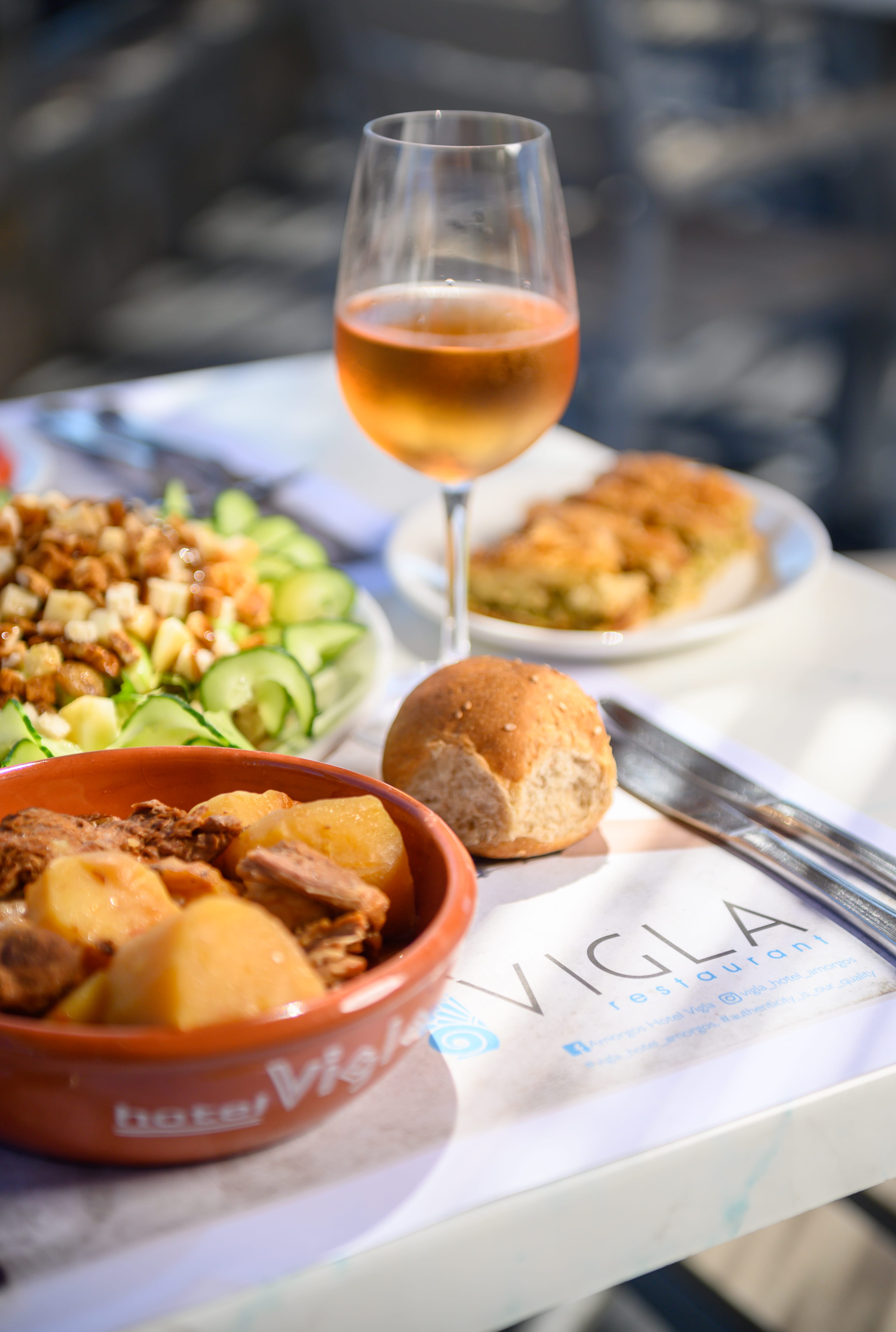 a table with food and a glass of wine