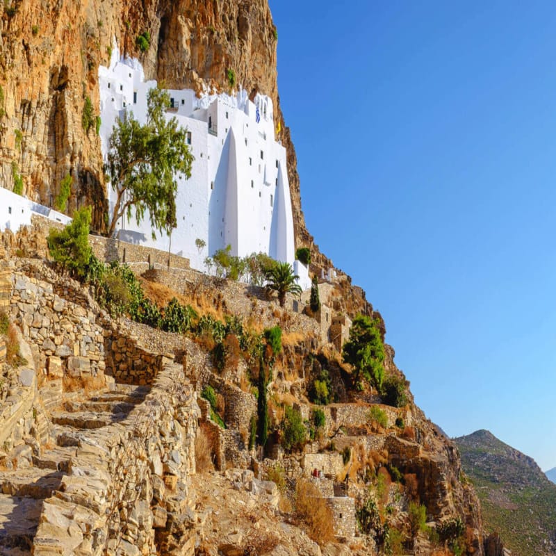 a rocky cliff with Amorgos