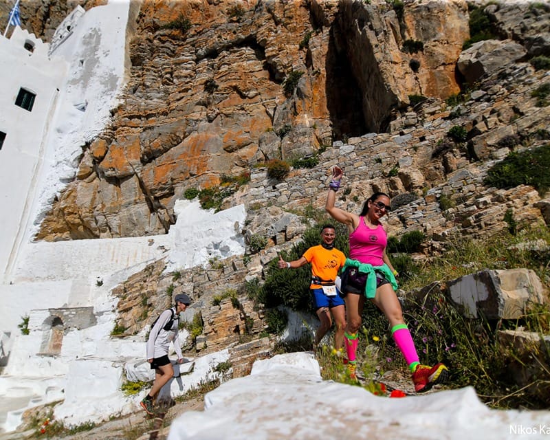 a group of people climbing a rock wall